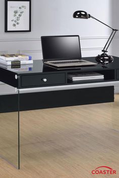 a glass desk with a laptop on it