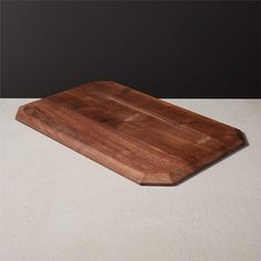 a wooden cutting board sitting on top of a table