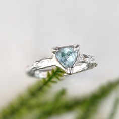 Rediscover love with our unique Aquamarine ring. Handcrafted in wax and Solid Silver, this captivating blue crystal ring boasts an organic textured band, ensuring its one-of-a-kind charm. Adorned with a mesmerizing trilliant shape Aquamarine, reflecting March's birthstone, this delicate ring signifies timeless love and individuality.T H E ∙ S M A L L ∙ D E T A I L S• Trilliant shape Aquamarine (6mm)• Sterling Silver molten bandM A T E R I A L ∙ O P T I O N S• Sterling Silver• Solid 14k GoldYou w Blue Crystal Ring, Rings Unique, Timeless Love, Aquamarine Ring, Aquamarine Rings, Crystal Ring, Delicate Rings, March Birth Stone, Crystal Rings