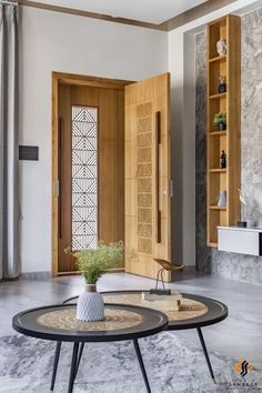 a living room with two coffee tables and a bookcase in the back ground area