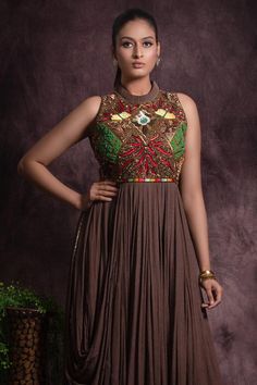 Brown in cut sleeves floor length flared gown embellished with multicolor sequin, bead work and thread embroidery on waist and cowl hem on one side.
Components: 1
Pattern: Embroidery
Type Of Work: Sequin, Beads
Neckline: Pleated collar
Sleeve Type: In cut sleeves
Fabric: Chinon, Lining: Cotton
Color: Brown
Other Details: 

Attached inner lining
Geometric and floral sequin embellishments
Length:
Gown(in inches): 59
Occasion: Cocktail, Reception - Aza Fashions Multicolor Maxi Gown With Resham Embroidery, Multicolor Resham Embroidered Maxi Gown, Fitted Floor-length Gown With Multicolor Embroidery, Designer Maxi Gown With Sequins, Designer Sequined Maxi Length Gown, Designer Sequined Maxi Gown, Designer Maxi Length Sequined Gown, Multicolor Embroidered Floor-length Reception Dress, Designer Maxi Dresses With Sequins