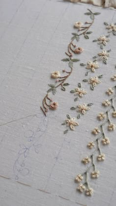 embroidered fabric with flowers and leaves on it