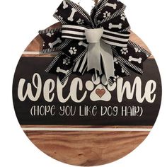 a wooden sign that says welcome hope you're dog hair with bones and bones on it