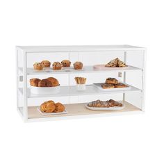 a bakery display case filled with lots of pastries and muffins on plates