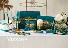 the table is set up with green and white flowers, candles, napkins, and other decorative items