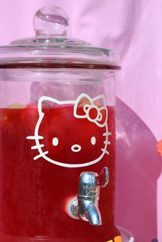 a hello kitty beverage dispenser is shown in front of a pink background