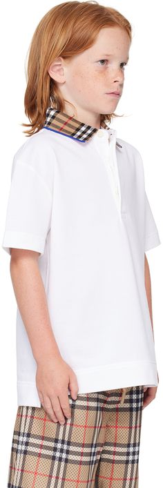 Organic cotton piqué polo. · Check pattern at knit spread collar · Three-button placket · Logo embroidered at front · Tennis-tail hem · Machine-wash Supplier color: White Model measures 48 / 121.9 cm tall and wears size 8Y. Burberry Size: child's height 3Y: 38.5 / 98 cm 4Y: 41 / 104 cm 6Y: 45.5 / 115.5 cm 8Y: 50.4 / 128 cm 10Y: 55.1 / 140 cm 12Y: 59.9 / 152 cm 14Y: 64.6 / 164 cm Spring Polo Shirt With Contrast Collar, Collared Polo Shirt With Buttons For Workwear, White Short Sleeve Polo Sweater For Work, Casual White Top With Fold Down Collar, Spring Cotton Polo Sweater With Button Closure, Collared Cotton Polo Sweater With Button Closure, White Seamless Collar Polo Shirt For Work, White Polo Shirt With Seamless Collar For Work, Spring Workwear Polo Shirt With Ribbed Collar