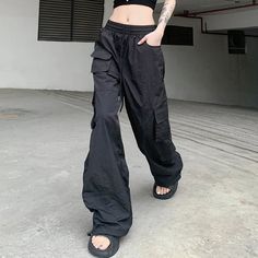 Get ready to elevate your street style with our High Waisted Utility Joggers. These joggers feature a trendy high waist and practical utility pockets, perfect for carrying all your essentials. Pair with your favorite sneakers for a comfortable and stylish look. (But don't worry, you won't actually have to jog in them.) Urban Cargo Pants With Functional Pockets For Streetwear, Urban Bottoms With Functional Pockets For Streetwear, Urban Streetwear Bottoms With Functional Pockets, Trendy Baggy Joggers With Drawstring, Casual Parachute Pants With Multiple Pockets For Streetwear, Baggy Urban Cargo Jeans For Outdoor Activities, Sporty Streetwear Joggers With Drawstring, Hip Hop Joggers With Drawstring For Streetwear, Sporty Joggers With Drawstring For Streetwear