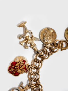 14kt Gold Plated Brass Coat Of Arms Charm Bracelet Enamel & Gold Toned Multi-Charms (Coat of Arms, Griffin Creature, Fig Leaves, Fleur-de-lis & other iconography) Charms Range from 15mm-35mm Double Link Chain Width: 8.6mm Length: 7.5'' The Vintage and Estate Jewelry pieces are pre-loved, and may have minor imperfections or slight discoloration. All Vintage and Estate Jewelry items are Final Sale. Griffin Creature, Lucky Charm Bracelet, Charms For Bracelets, Vintage Charm Bracelet, Fig Leaves, Pearl Gemstone, Gold Enamel, Lucky Charm, Silver Pearls