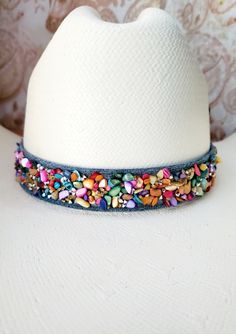 Blue Jean Denim Bling Hat Band, made with Shells, Beads, Rhinestones, Crystal and Glass on Medium or Dark Blue Jean Demin material.  Choose Rainbow, Rainbow with Rhinestone Rim, or Blue.  Add a little jazz to your hat with some blue jeans and rhinestones.   Beaded Hatband includes adjustable tie in back. Shown on a size 7 hat.  Designed and Handmade by me at Blue Eyes Designs.  Hat is not included. See my other blue jean bling hatbands here:  https://www.etsy.com/shop/BlueEyesDesignsHB?ref=seller-platform-mcnav&section_id=42175406 I also make custom, made to order cowboy or cowgirl hatbands that can be made as single, 2 strand, 3 strand or 4 strand horn or bone beads. Hatbands can be custom made to the size of your hat and include buckskin tie straps in back to make it adjustable. When you Bling Hat, Beaded Hat Bands, Boot Bracelet, Beaded Hat, Large Hats, Decorative Beads, Cowboy Cowgirl, Handmade Hat, Bone Beads