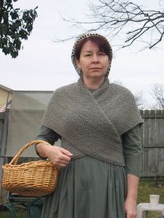 a woman holding a wicker basket in her hand