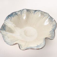 a white and blue flower shaped dish on a table