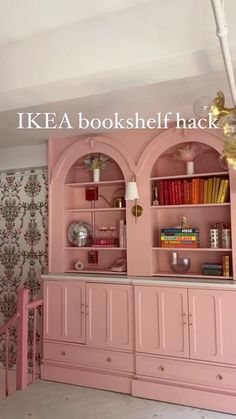 a pink bookcase in the corner of a room