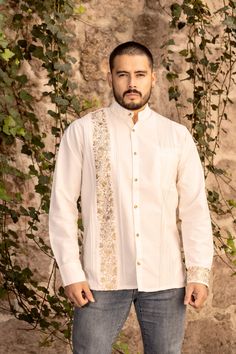 This beautiful Traditional Guayabera for Men is floral embroidered and adds a sophisticated flare to your wardrobe.  It is made out of fine Mexican cotton and is completely embroidered by hand with golden silk thread. This elegant long sleeve button up Shirt is perfect for special occasions such as Mexican Fiestas, Quinceañeras, Weddings, etc. The shirt is sent in either a Sport or Band collar, it depends on the one we have available. This guayabera is made by Mexican Artisans in Oaxaca, Mexico. Elegant Festive Shirt With Floral Embroidery, Elegant Floral Embroidery Shirt For Festive Season, Elegant Embroidered Shirt For Festive Occasions, Elegant Festive Embroidered Shirt, Long Sleeve Cotton Bandhgala For Traditional Ceremonies, Cotton Long Sleeve Bandhgala For Traditional Ceremonies, Festive Long Sleeve Embroidered Shirt, Cotton Bandhgala For Traditional Ceremonies, Traditional Long Sleeve Wedding Shirt