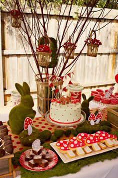 a table topped with lots of cakes and desserts