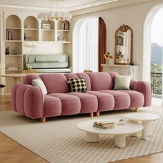 a living room with pink couches and white coffee table in front of an open window