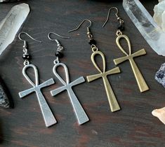 These lovely handmade earrings feature a ankh pendant paired with faceted black beads. Product details Measures 3 1/4 inches total length Ankh is plated; ear wire is nickel free. Also available with Hematite beads, see last photo. Available in our earrings section. Thank you for supporting our small business, Enchanting Creature! VISIT MY SHOPS HERE * http://www.etsy.com/shop/HappyCatHouse * http://www.Etsy.com/shop/AnEnchantingCreature CONNECT * http://www.facebook.com/EnchantingCreature * http Black Ankh Metal Jewelry, Handmade Symbolic Black Earrings, Handmade Symbolic Ankh Earrings, Handmade Adjustable Ankh Earrings, Ankh Pendant, Goth Earrings, Hematite Beads, Large Earrings, Buy Handmade