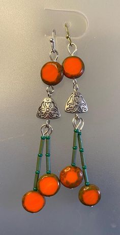 Vivid Orange Czech Glass beads inspired these colorful earrings. I added green seed beads to set off the Autumn Orange. They are sleek, simple and eye catching and perfect for anyone that likes brilliant colors. Czech Glass Jewelry, Window Panes, Autumn Orange, Window Pane, Colorful Earrings, Etsy Earrings Dangle, Czech Glass Beads, Glass Jewelry, Jewelry Ideas