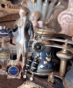 an assortment of perfume bottles and figurines on a table