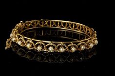 "This is a very beautiful, vintage and unique PEARLS 14K GOLD c. 1970 bangle bracelet (weight 22.1g). The bracelet has a marvelous and chic style, rope filigree ornament with 11 white luster pearls (2.5 mm) and 14K gold (bottom has 14K). The bracelet has a very extravagant and elegant feel to it. It measures size 6 1/2\" x 5/16\". The bracelet is in very good condition. 0.7 GLM" Luxury Victorian Gold Bracelet For Anniversary, Luxury Victorian Gold Bracelet With Intricate Design, Vintage Yellow Gold Pearl Bracelet For Wedding, Vintage Gold Pearl Bangle Bracelet, Vintage Yellow Gold Pearl Bracelet For Formal Occasions, Elegant Pearl Bracelet With Intricate Design For Wedding, Elegant Pearl Bracelet For Wedding With Intricate Design, Elegant Wedding Pearl Bracelet With Intricate Design, Fine Jewelry Pearl Bangle Bracelet For Wedding