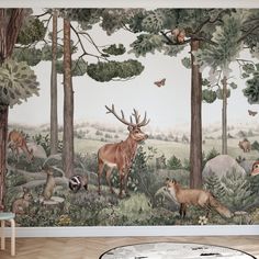 a wall mural with animals in the forest