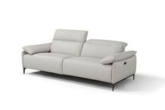 a white leather couch sitting on top of a white floor