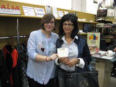 two women standing next to each other in a store