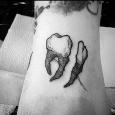 a black and white photo of a person's foot with two toothbrushes on it