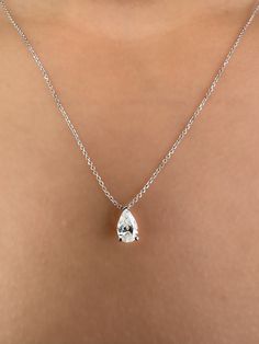 This Beautiful timeless floating diamond pendant is set with a lab-grown pear-shaped diamond in 14k solid gold. The photos show a 0.75ct pear-shaped lab-grown diamond. All of our diamonds are high-quality D color, VS1 clarity. Each diamond is securely set in a Prong setting, radiating sophistication with every glance. Every diamond is expertly positioned to reflect maximum light and brilliance that tells your forever love story. The pendant and chain are made of 14k solid gold and feature a spring clasp. Designed for comfort, this pear diamond necklace can easily be layered with other necklaces. This necklace is sure to bring a smile to her face and become a cherished addition to her jewelry collection. Our collection offers a variety of sizes and carat weights to suit diverse preferences. Timeless Pear-shaped Diamond Necklace For Anniversary, Pear-shaped Brilliant Cut Diamond White Necklace, Formal Pear-shaped Diamond Necklace With Vvs Clarity, Formal Vvs Clarity Pear-shaped Diamond Necklace, Formal Pear-shaped Brilliant Cut Diamond Necklace, Elegant Diamond Solitaire Drop Necklace, Teardrop White Gold Diamond Necklace With Brilliant Cut, Elegant Diamond Drop Solitaire Necklace, Classic Brilliant Cut Pear-shaped Diamond Necklace