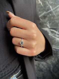 a woman's hand with a diamond ring on it