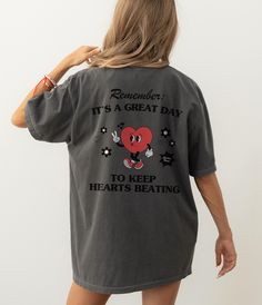 a woman wearing a t - shirt that says, remember it's a great day to keep hearts beating