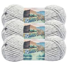 three skeins of yarn with the words home town written on them in white