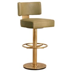 a gold metal bar stool with a beige leather upholstered back and foot rest