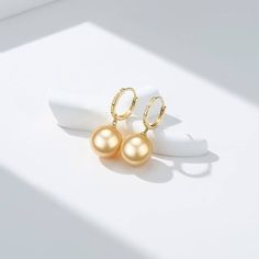 Golden South Sea Pearl Daisy Earrings Make your ears shine brighter than the stars with House Of Pearls’ Golden South Sea Pearl & Daisy Earrings. Crafted with solid gold pearls, these earrings will add the perfect touch of elegance to your everyday look. With their golden Hoops, these earrings will move and catch the light, adding a unique sparkle to your wardrobe. This popular earring design features AAA-AAAA quality. Material: 18k Gold with Golden South Sea Pearls Choose your pearl grade and p Gold High Luster Earrings, High Luster Gold Earrings, Gold High Luster Pearl Earrings, Yellow Gold High Luster Drop Earrings, Hypoallergenic Gold Pearl Earrings Fine Jewelry, Hypoallergenic Gold Pearl Earrings, High Luster 14k Gold Earrings, Elegant Yellow Dangle Hoop Earrings, Elegant Yellow Hoop Earrings As Gift