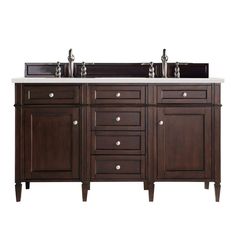 a double sink vanity with two mirrors above it and drawers below the sinks is dark wood