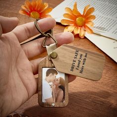 a wooden keychain with a photo attached to it