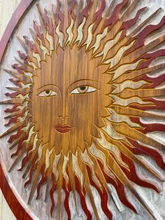 a wooden sun face on the side of a building