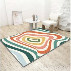 a room with a rug, chair and table on the floor in front of it