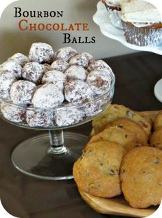 there are several desserts on the table and one is in a glass bowl with powdered sugar