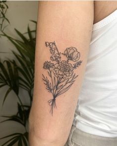 a black and white flower tattoo on the arm