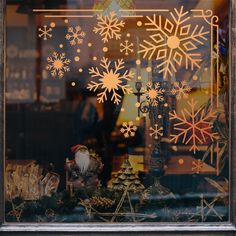 a window with snowflakes and other decorations in it