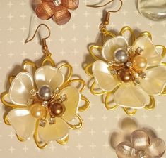 All of my items are one-of-a-kind handmade originals, and I do take special orders. These are ivory floral multi-colored pearl earrings. Enjoy them. Elegant Beige Flower Earrings Gift, Elegant Beige Flower Earrings For Gift, Beige Flower Earrings As Gift, Handmade Gold Pearl Flower Earrings, Handmade Gold Pearl Earrings In Flower Shape, Beige Flower-shaped Earrings For Gift, Beige Flower Earrings For Gift, Handmade Beige Flower-shaped Earrings, Handmade Pearl White Flower Earrings