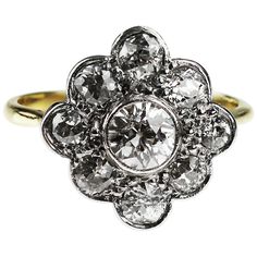 A show-stopping vintage 18ct gold diamond cluster ring. The central diamond weighing 0.40ct is framed by a glittering arrangement of nine Old-European cut diamonds (totalling 0.75ct), which form a beautiful cluster resembling a flower. The diamonds are set in platinum for added sparkle, while the band is a warm 18ct yellow gold. Total diamond weight is 1.15 ct. Diamond Assessed Colour H/I, Diamond Assessed Clarity SI The ring head length 14.8 mm x width 14.2 mm UK ring size "K" / US "5.5" / German "51 (16.2)" / Spain "10.5" / France "50.5" / Italy "10" / Japan "10" and it can be resized upon request. Natural Pearl Ring, European Cut Diamond Ring, Contemporary Engagement Rings, Vintage Cocktail Ring, Cluster Engagement Ring, Deco Engagement Ring, Art Deco Engagement Ring, European Cut Diamonds, Art Deco Diamond