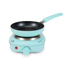 a small blue frying pan on top of an electric burner with a handle