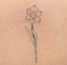 a small flower on the back of a woman's stomach