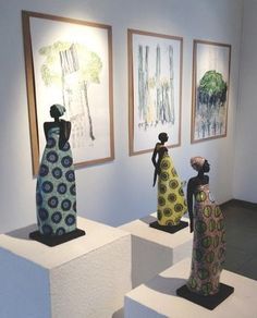 three sculptures on pedestals in an art gallery