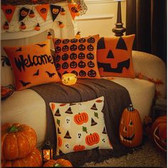 halloween pillows and pumpkins on a couch