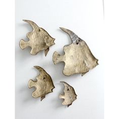 four pieces of metal that look like fish