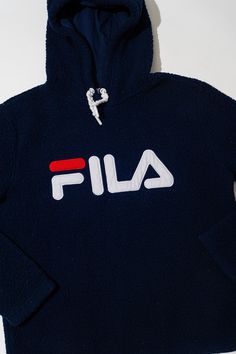 "This is a vintage fleece hoodie by Fila. The sweater is a very soft navy blue material. The drawstrings of the hood are braided white strings. The front of the fleece showcases a large FILA in red and white. Tina the Mannequin loves how comfy this fleece is! She wants to wear it out and then wear it to bed.  Tina love the navy blue color too. Tina thinks you will love this fleece so much! Or maybe it's the perfect gift for your loved on! Tina will have it wrapped up for you right away! Tag: Fila Size: M Measurements; Chest: 20.5\" Sleeve: 24\" Length: 23.5\" Materials: Cotton, Polyester Stored in a smoke-free, pet-free environment. Please note that not all screens are properly color calibrated. All images are taken with professional photo gear and edited using professionally calibrated sc Fleece Sweatshirt With Drawstring, Navy Hooded Sweatshirt With Drawstring, Navy Hoodie For Winter Loungewear, Navy Hooded Hoodie For Loungewear, Navy Winter Hoodie For Loungewear, Navy Hoodie With Drawstring For Loungewear, Navy Drawstring Hood Loungewear Hoodie, Soft Navy Blue, Photo Gear