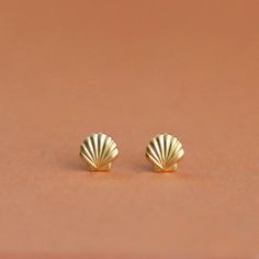 "Tiny 14k Solid Gold Minimalist Seashell Stud Earrings, Dainty and Unique 14k Yellow or White Solid Gold Nautical Earrings for Women. A pair of unique and minimalist stud earrings that will look great with any outfit you'll wear and add BLING to your look. They are light and comfortable to wear, perfect as second or third-hole earrings, and add a minimalist statement to anything you'll wear. A must-have earrings for any style! Material: ♦ 14K Yellow / White Gold Please choose from the drop-down Yellow Gold Shell-shaped Earrings For Pierced Ears, Yellow Gold Shell-shaped Earrings, Shell-shaped Yellow Gold Earrings Gift, Shell-shaped Yellow Gold Earrings For Gifts, Yellow Gold Shell-shaped Earrings Gift, Minimalist Stud Earrings, Tiny Gold Studs, Nautical Earrings, Seashell Earrings